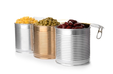 Photo of Tin cans with conserved vegetables on white background