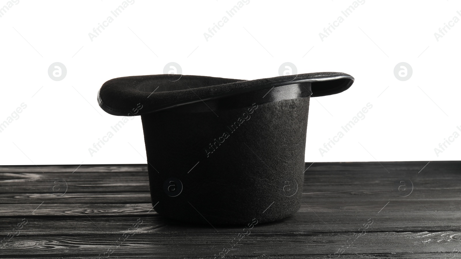 Photo of Magician's hat on wooden table against white background