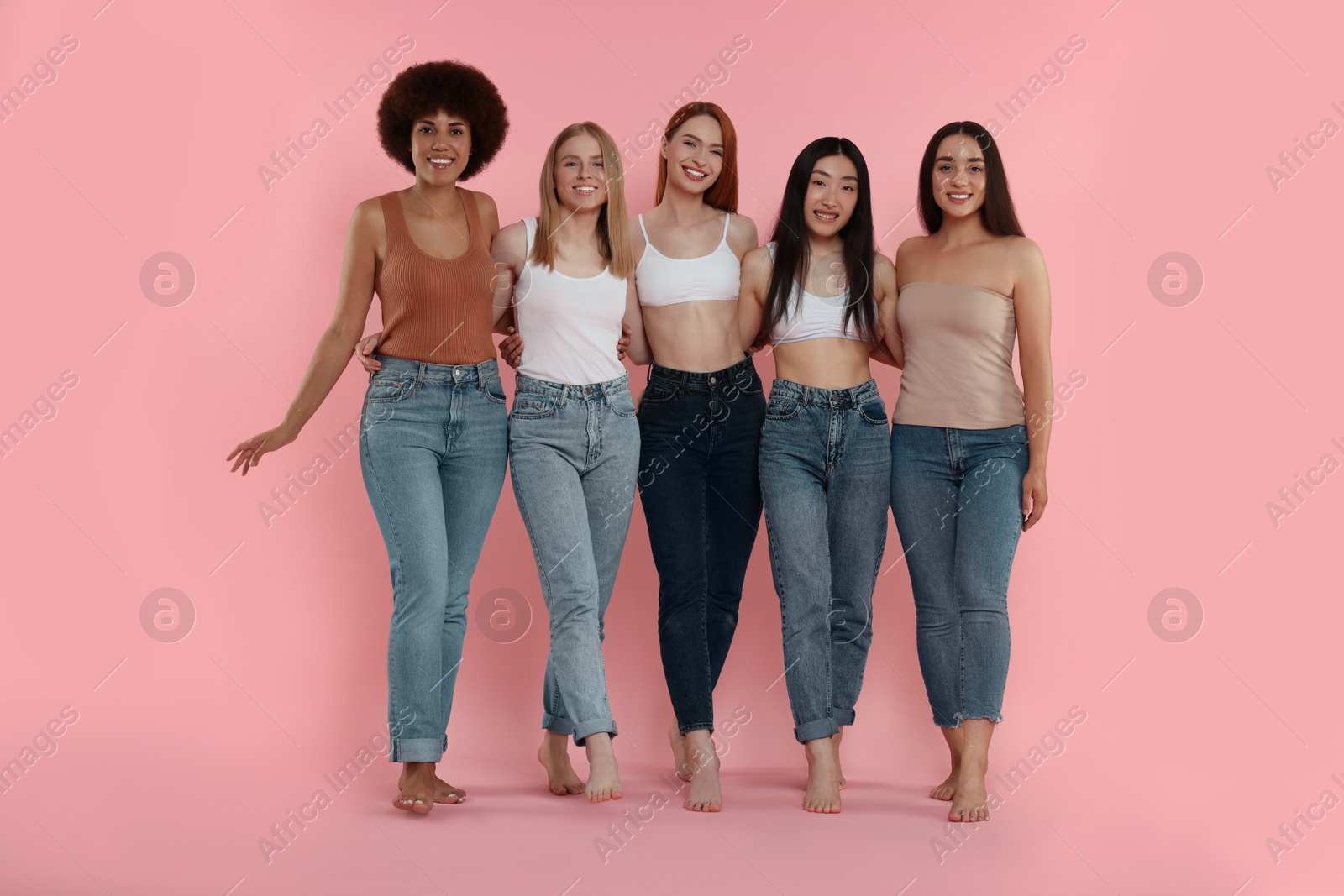 Photo of Group of beautiful young women on pink background