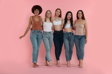 Group of beautiful young women on pink background