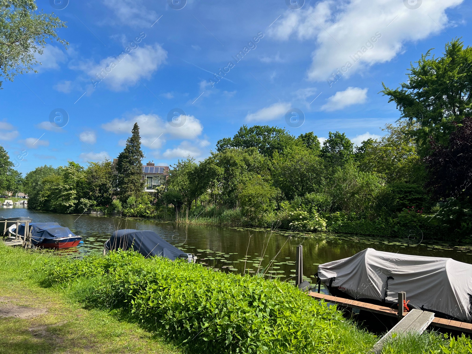 Photo of Beautiful view of canal with moored boats on sunny day