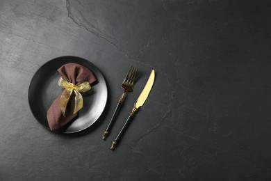 Stylish setting with elegant cutlery on grey textured table, flat lay. Space for text