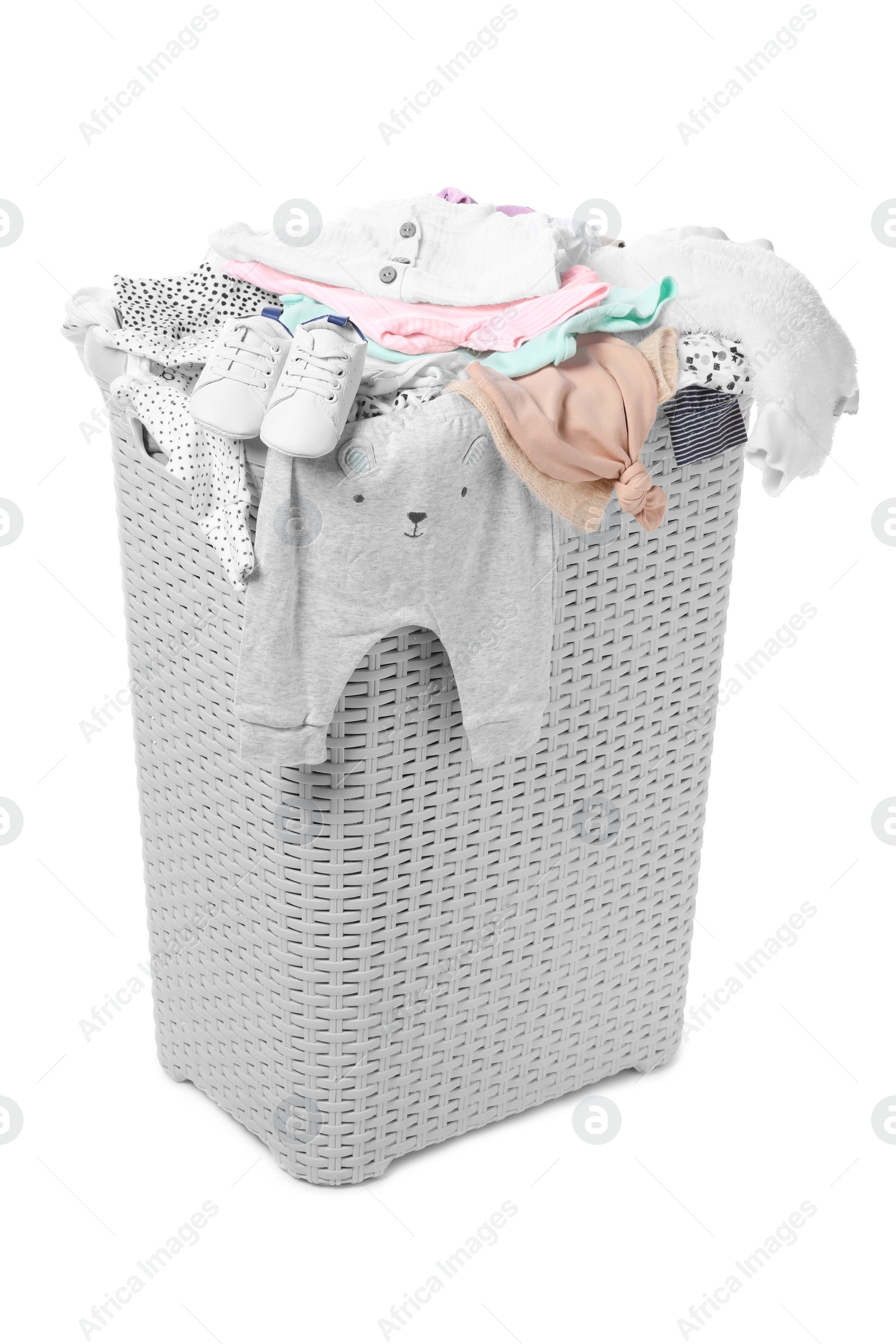 Photo of Laundry basket with baby clothes isolated on white