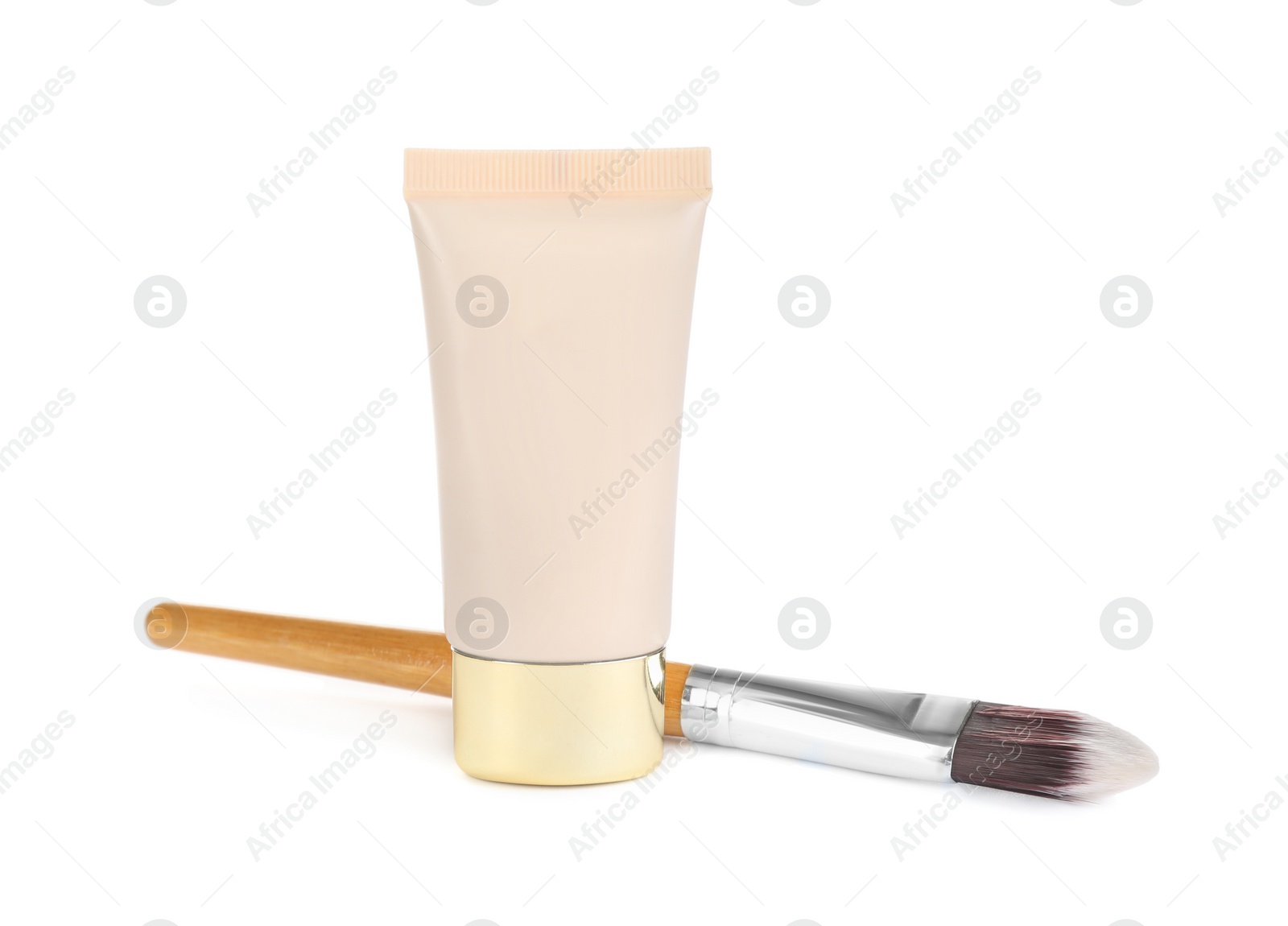 Photo of Tube of skin foundation and brush isolated on white. Makeup product