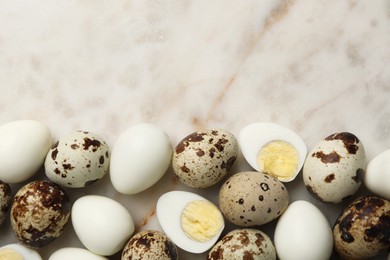 Photo of Unpeeled and peeled hard boiled quail eggs on light table, flat lay. Space for text