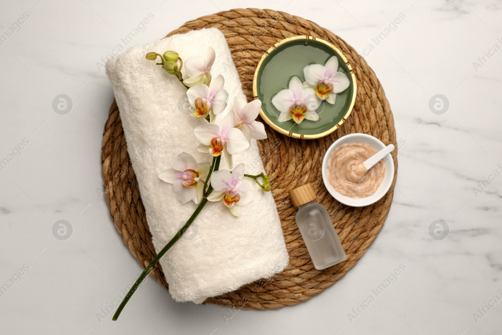 Photo of Composition with different spa products and flowers on white marble table, top view