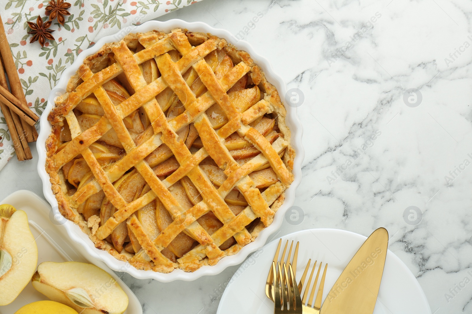 Photo of Tasty homemade quince pie served on white marble table, flat lay. Space for text