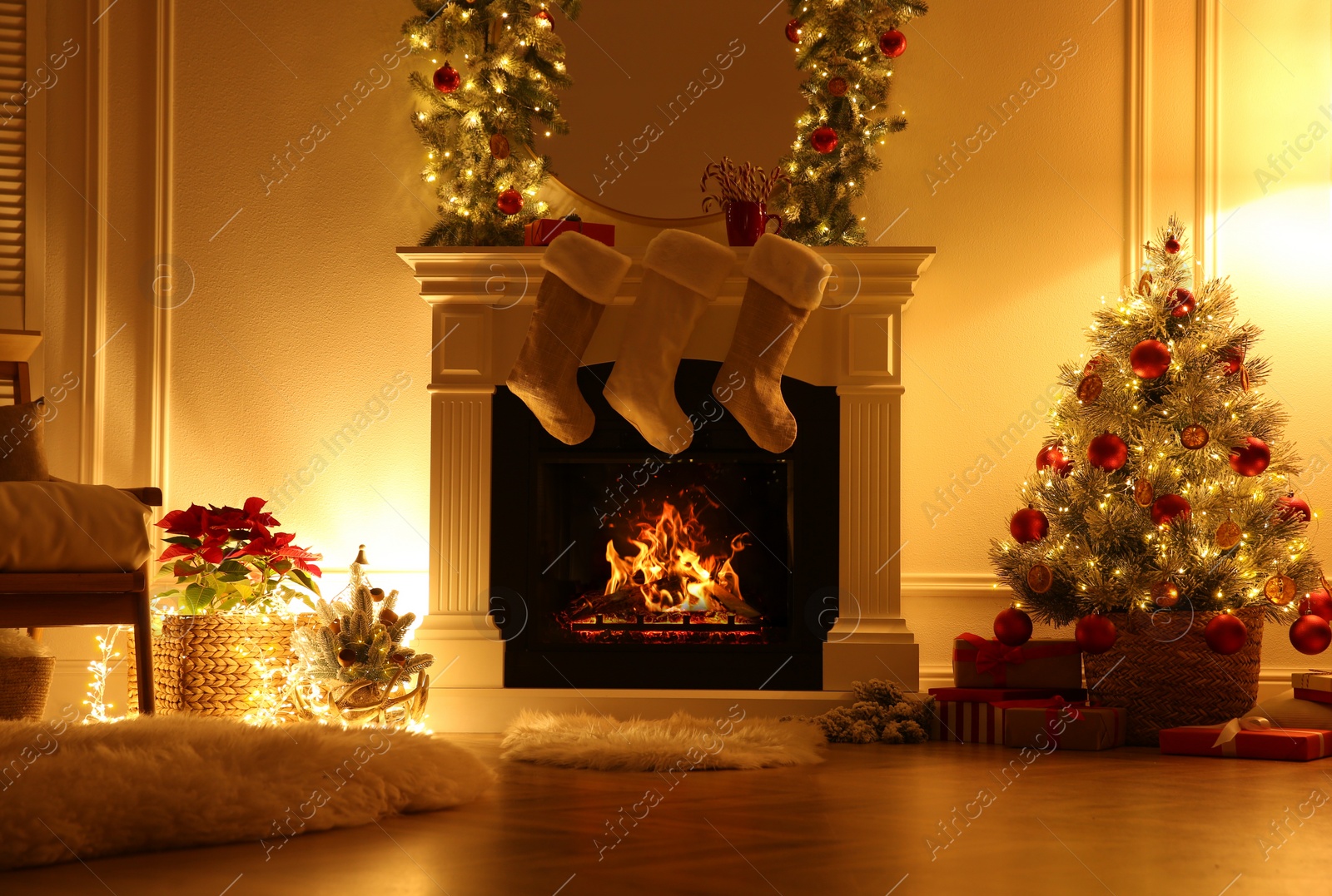 Photo of Fireplace with Christmas stockings in beautifully decorated living room