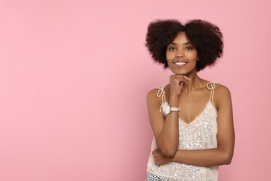 Photo of Portrait of smiling African American woman on pink background. Space for text