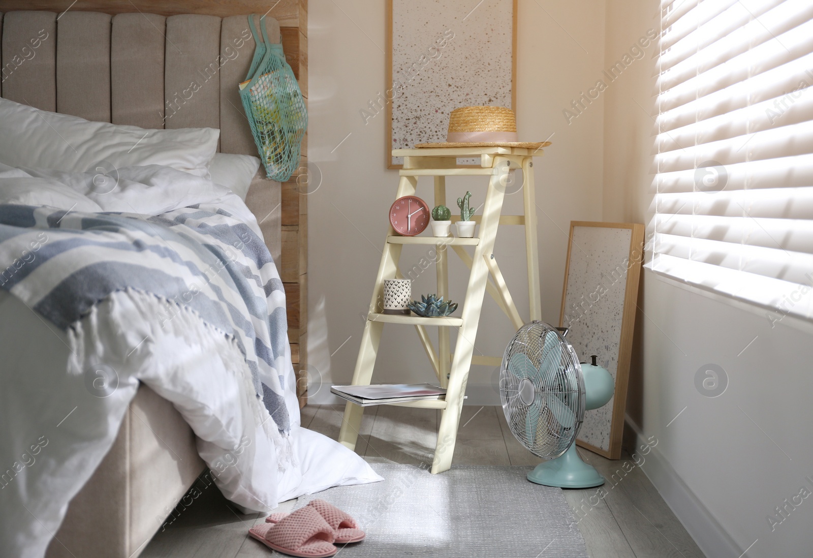 Photo of Decorative ladder with different stuff in stylish bedroom. Idea for interior design