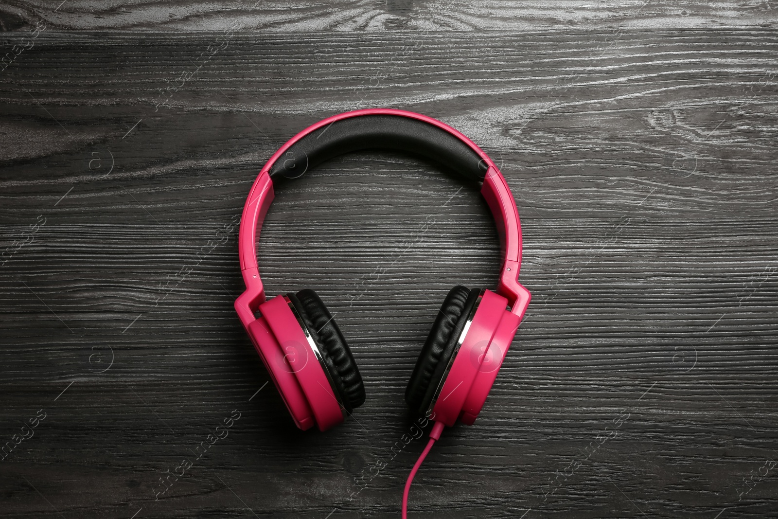 Photo of Stylish headphones on wooden background, top view