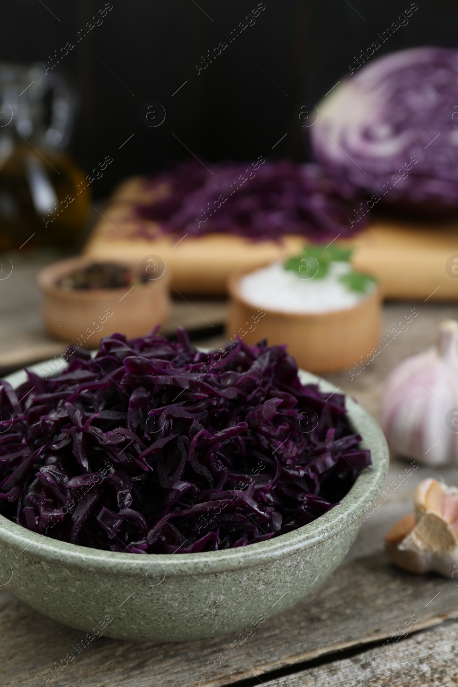 Photo of Tasty red cabbage sauerkraut with parsley on wooden table