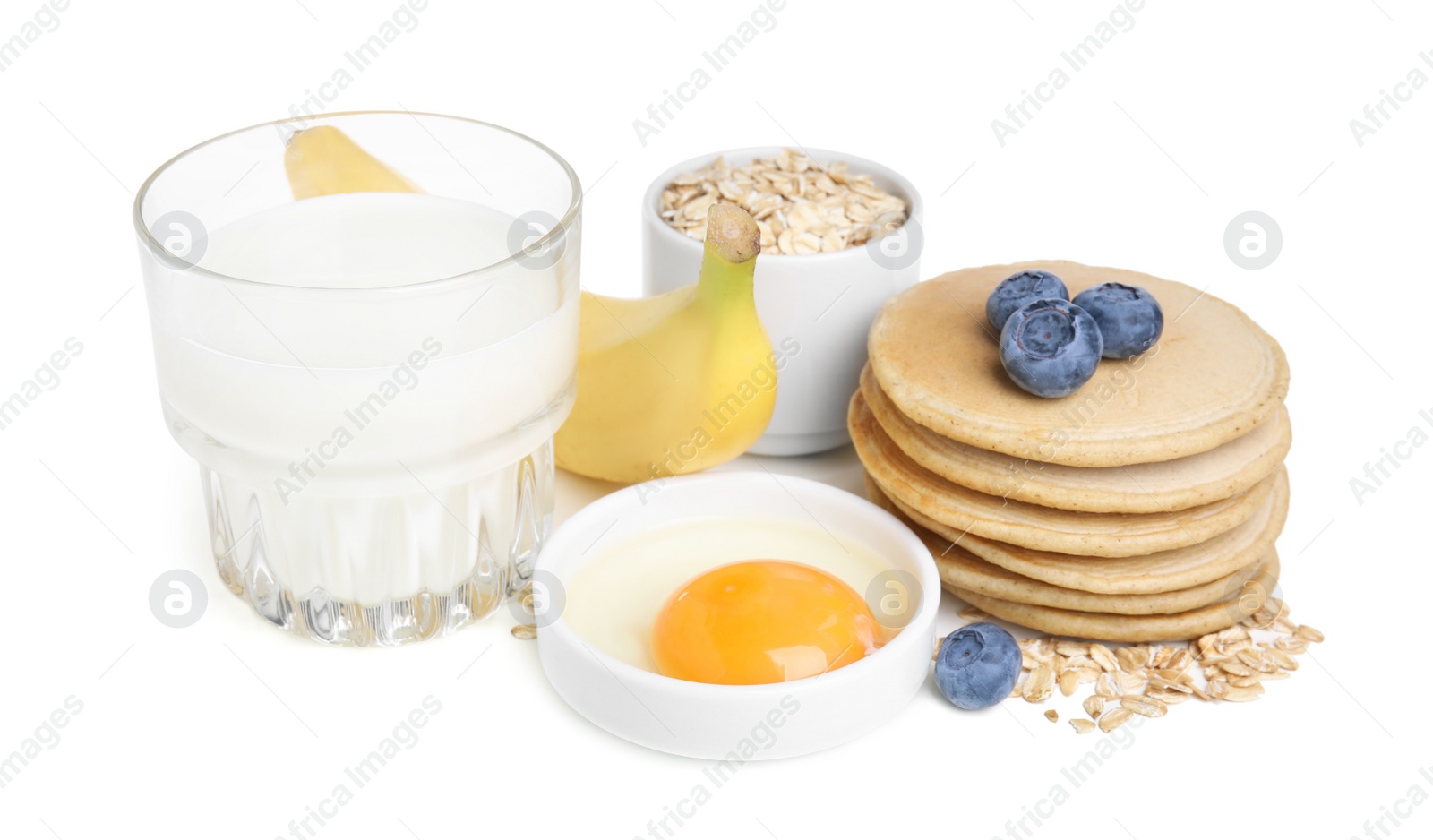 Photo of Tasty oatmeal pancakes and ingredients on white background