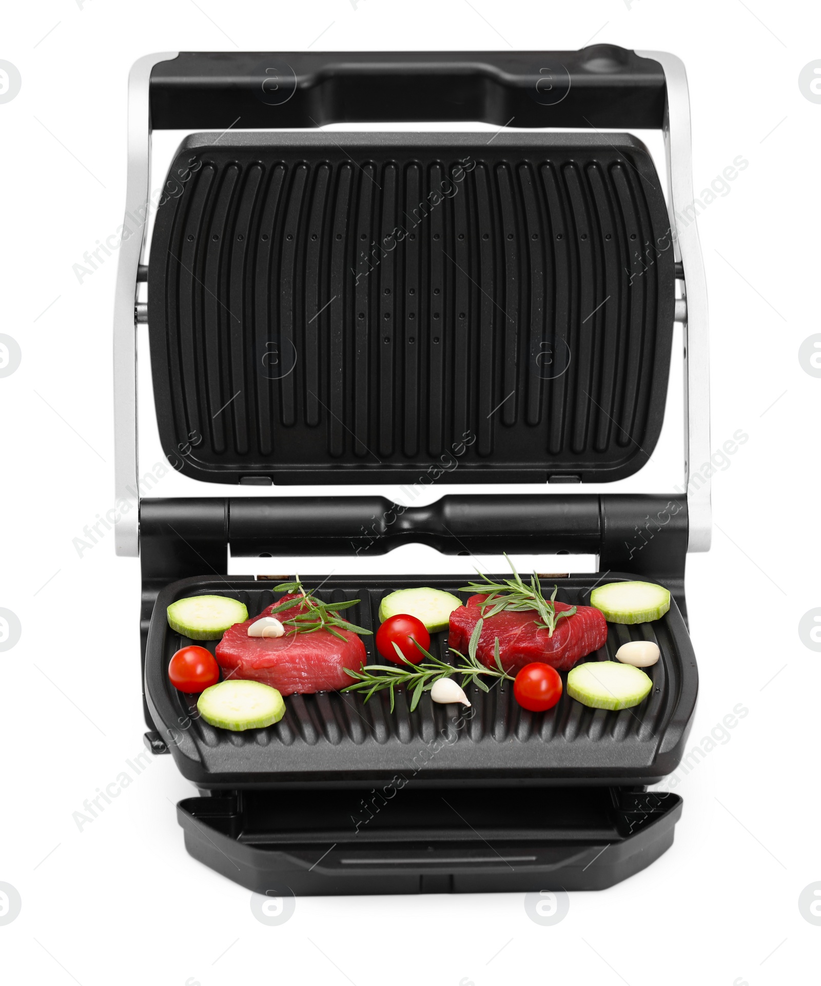 Photo of Electric grill with raw meat, rosemary and vegetables isolated on white