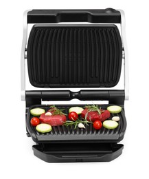 Electric grill with raw meat, rosemary and vegetables isolated on white