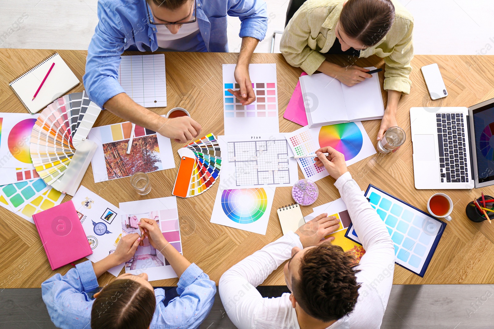 Photo of Professional team of interior designers working at table, top view