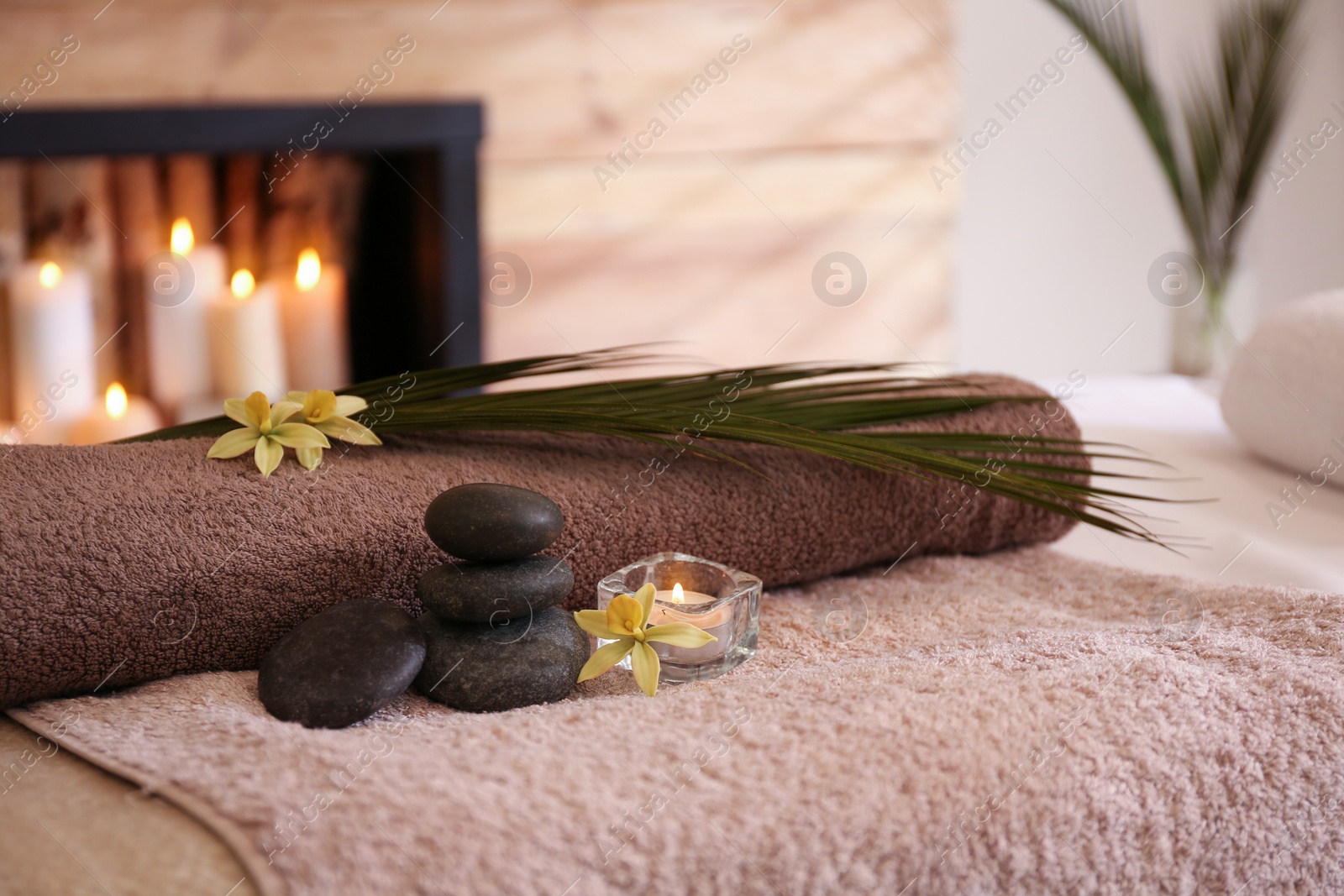 Photo of Beautiful spa accessories on massage table in room