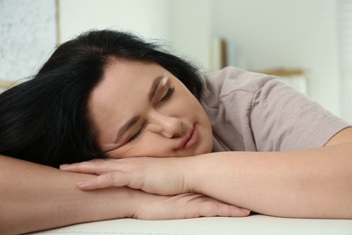 Photo of Lazy overweight woman sleeping at home, closeup