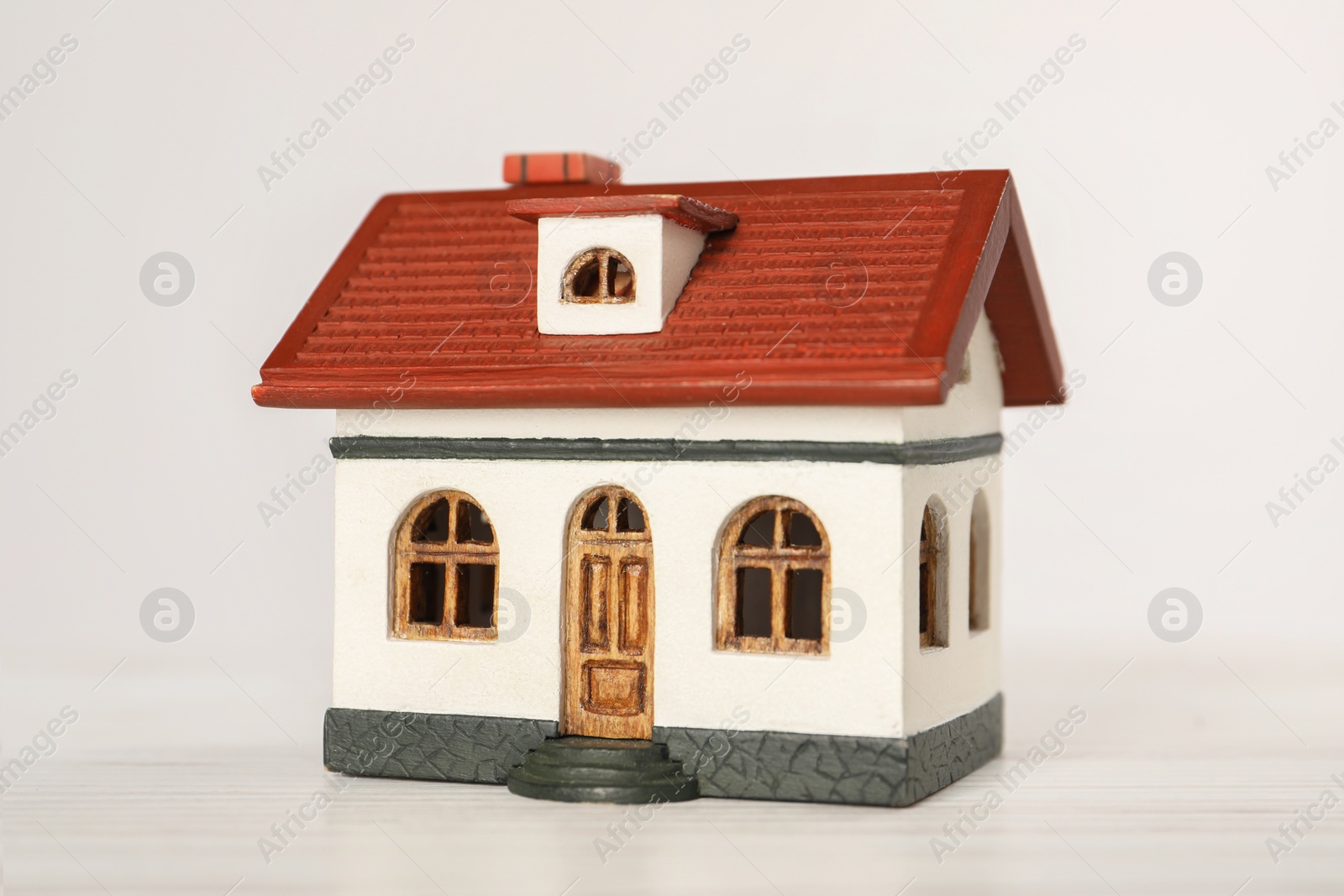 Photo of Mortgage concept. House model on white wooden table