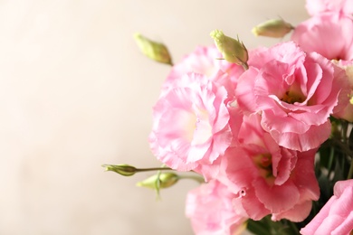 Photo of Beautiful bouquet of Eustoma flowers on color background, close up view