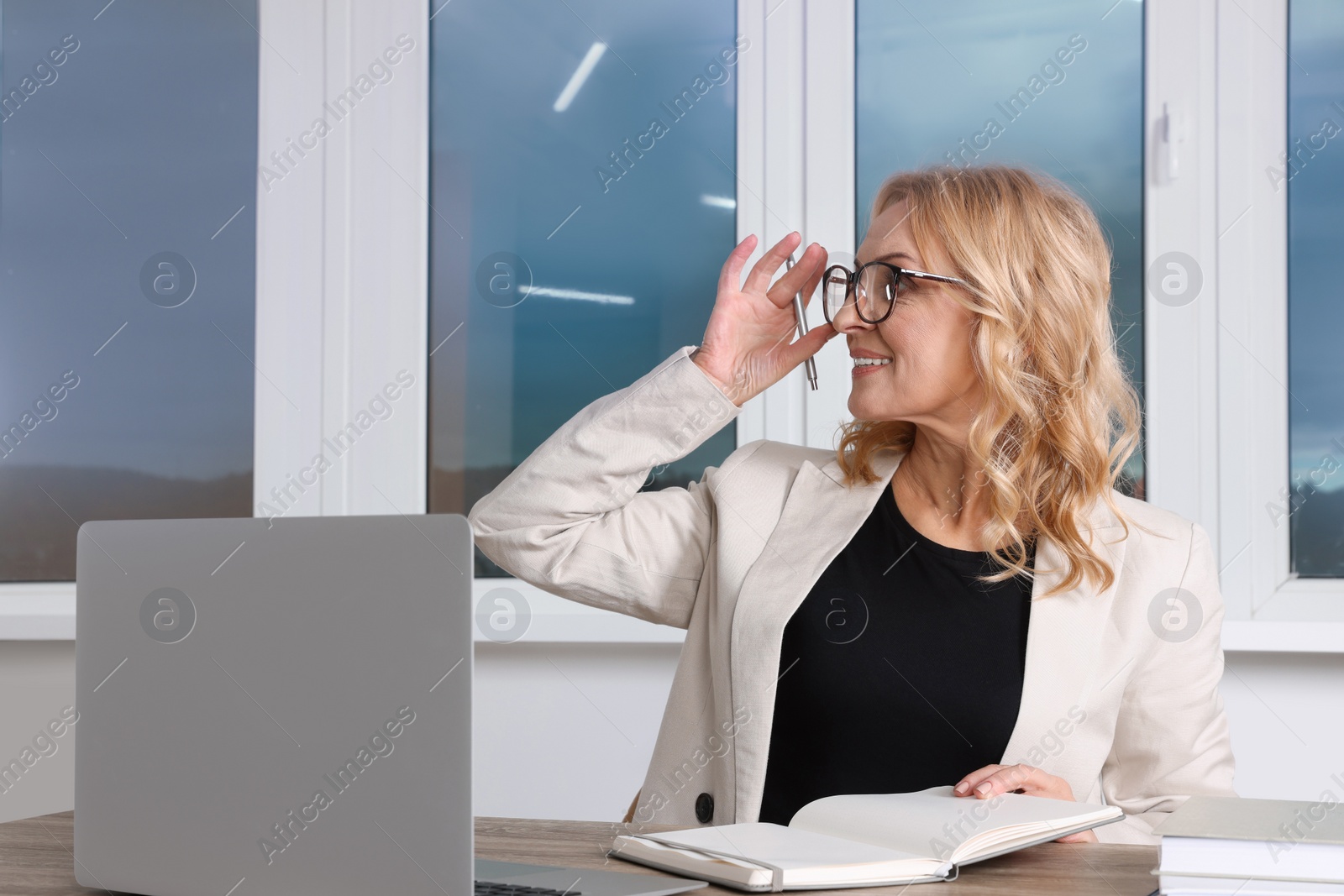 Photo of Lady boss working near laptop at desk in office. Successful businesswoman