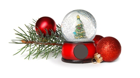 Photo of Magical snow globe with pine branches and Christmas balls on white background