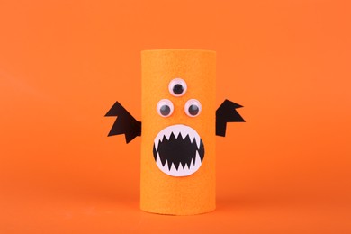 Spooky monster on orange background. Handmade Halloween decoration