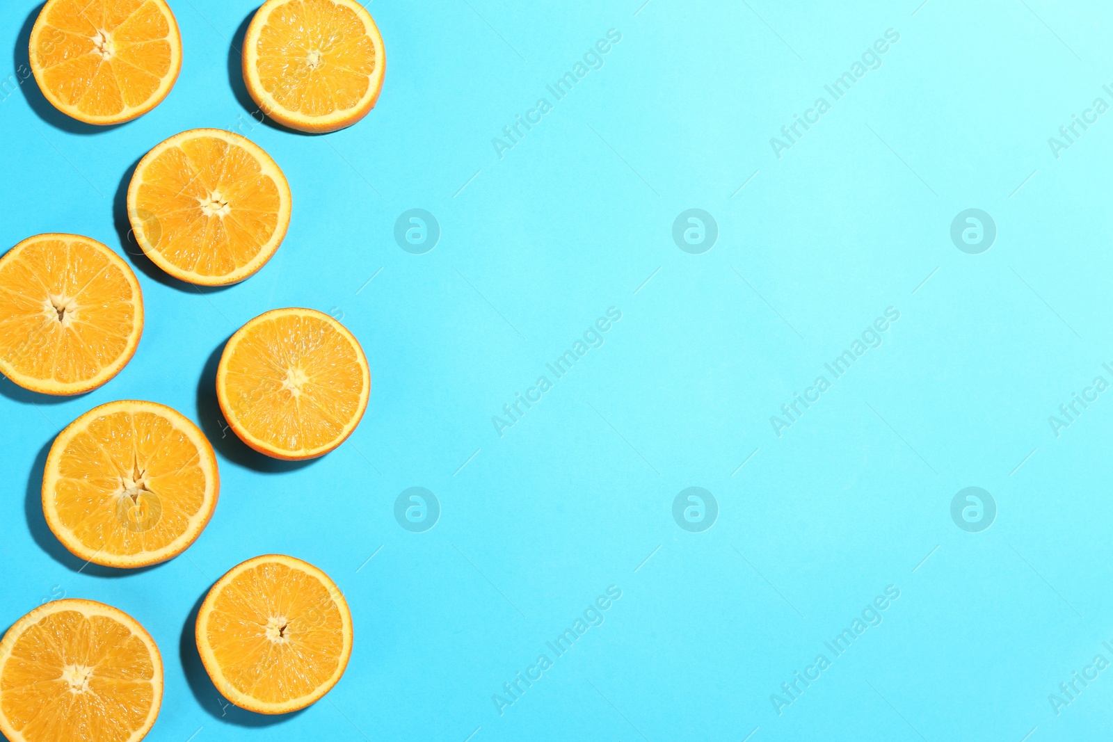 Photo of Flat lay composition with fresh ripe oranges on turquoise background. Space for text