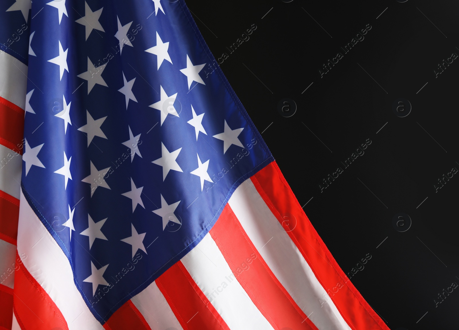 Photo of American flag on black background, closeup with space for text. Memorial Day