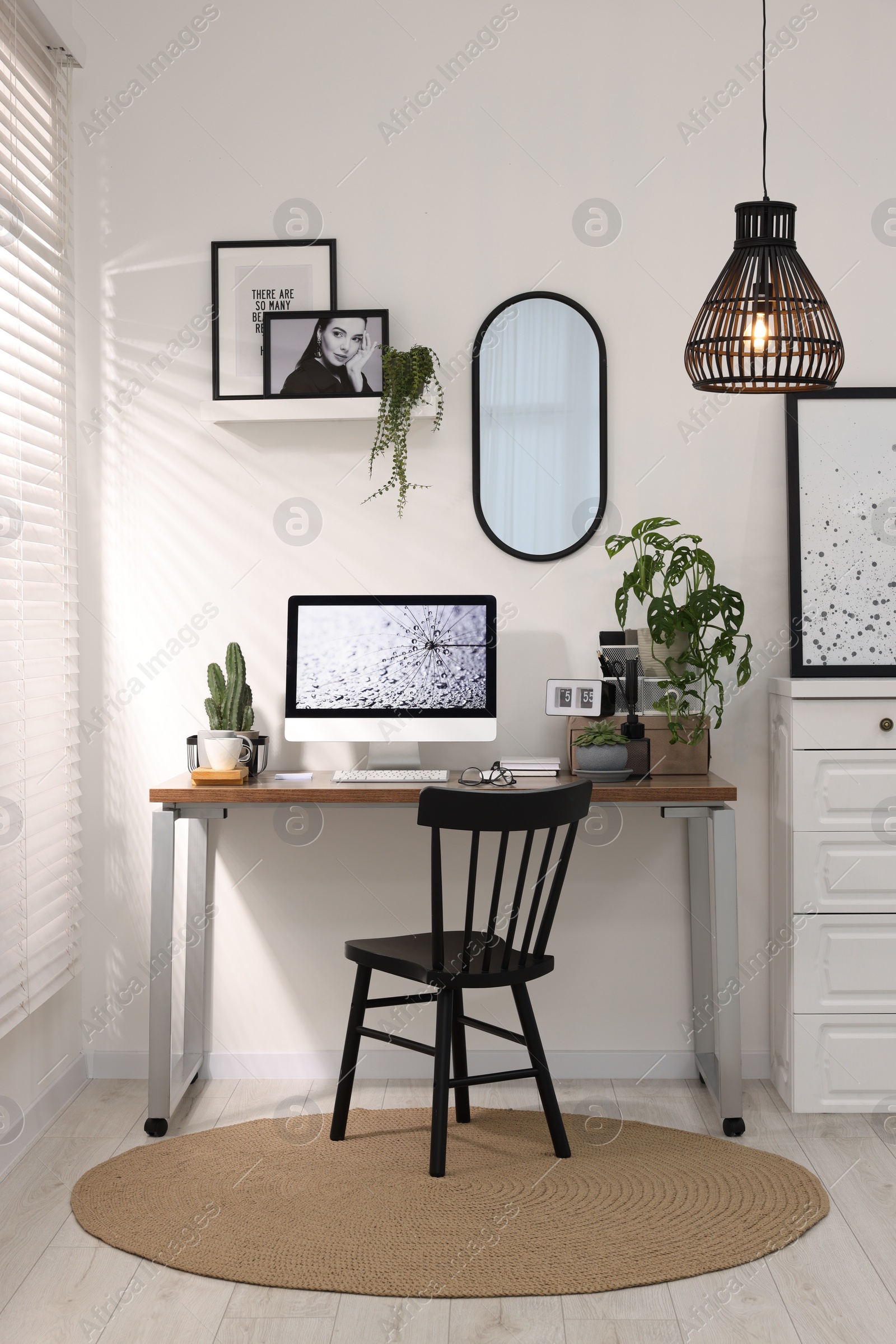 Photo of Cozy workspace with computer on wooden desk at home