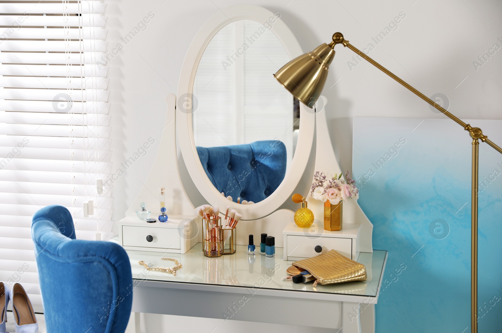 Photo of Elegant dressing table and blue chair in stylish room interior