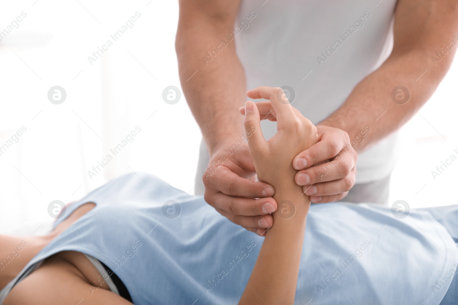 Photo of Young woman receiving massage in salon, closeup