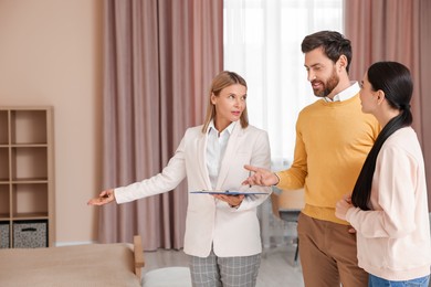 Real estate agent working with couple in new apartment