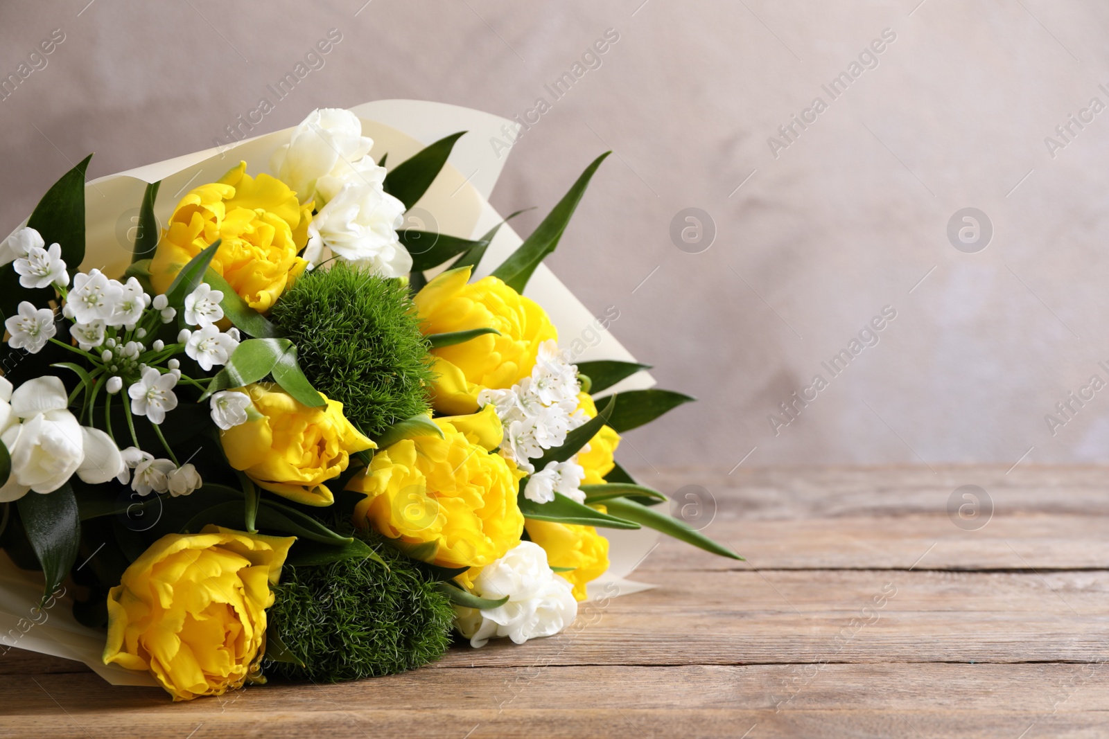 Photo of Beautiful bouquet with peony tulips on wooden table. Space for text