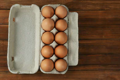 Raw chicken eggs on wooden table, top view