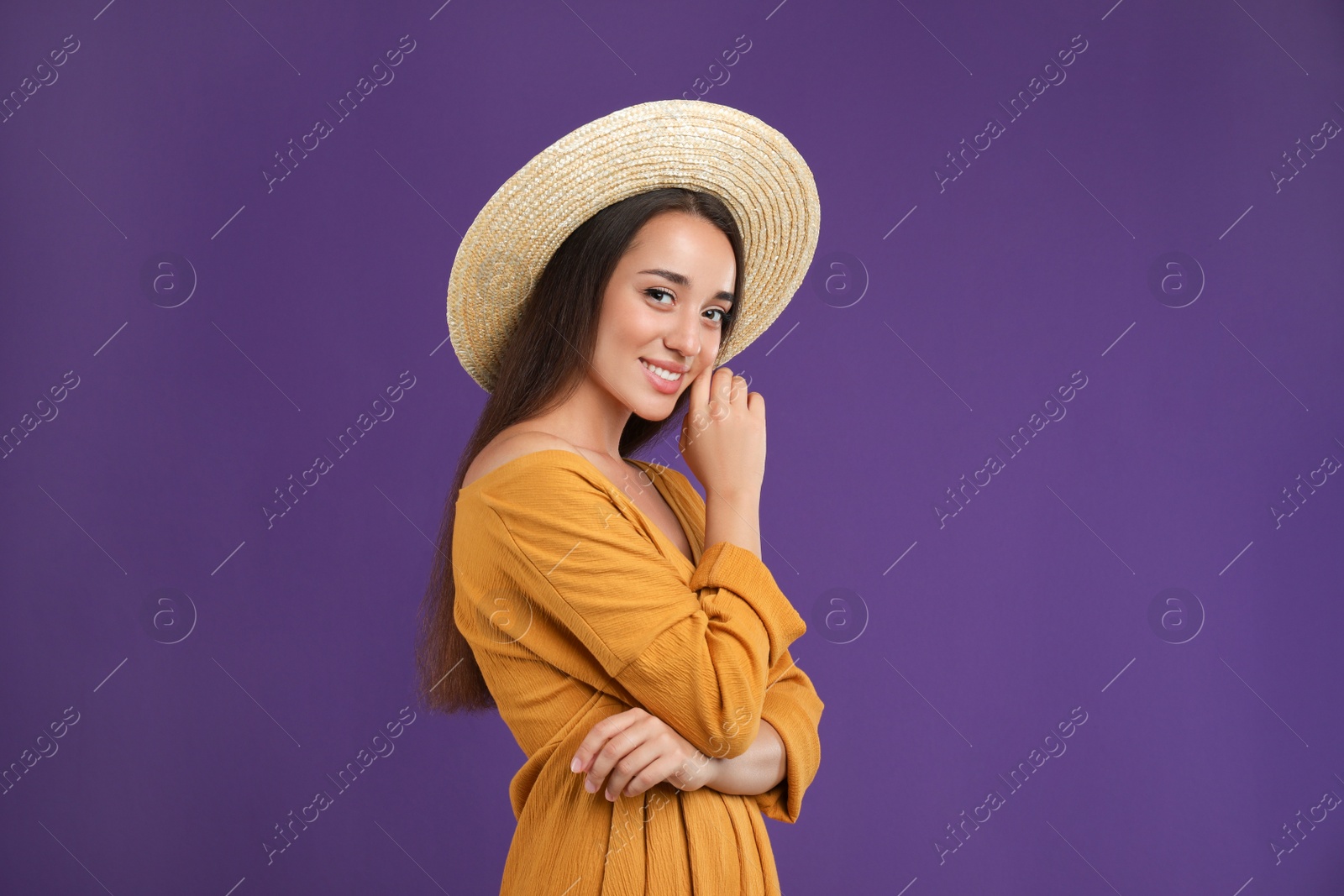 Photo of Young woman wearing stylish dress on purple background