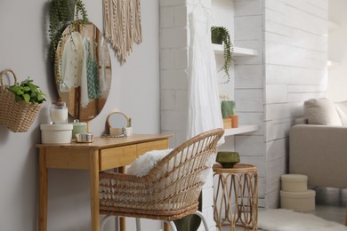 Photo of Wooden dressing table with decorative elements in room