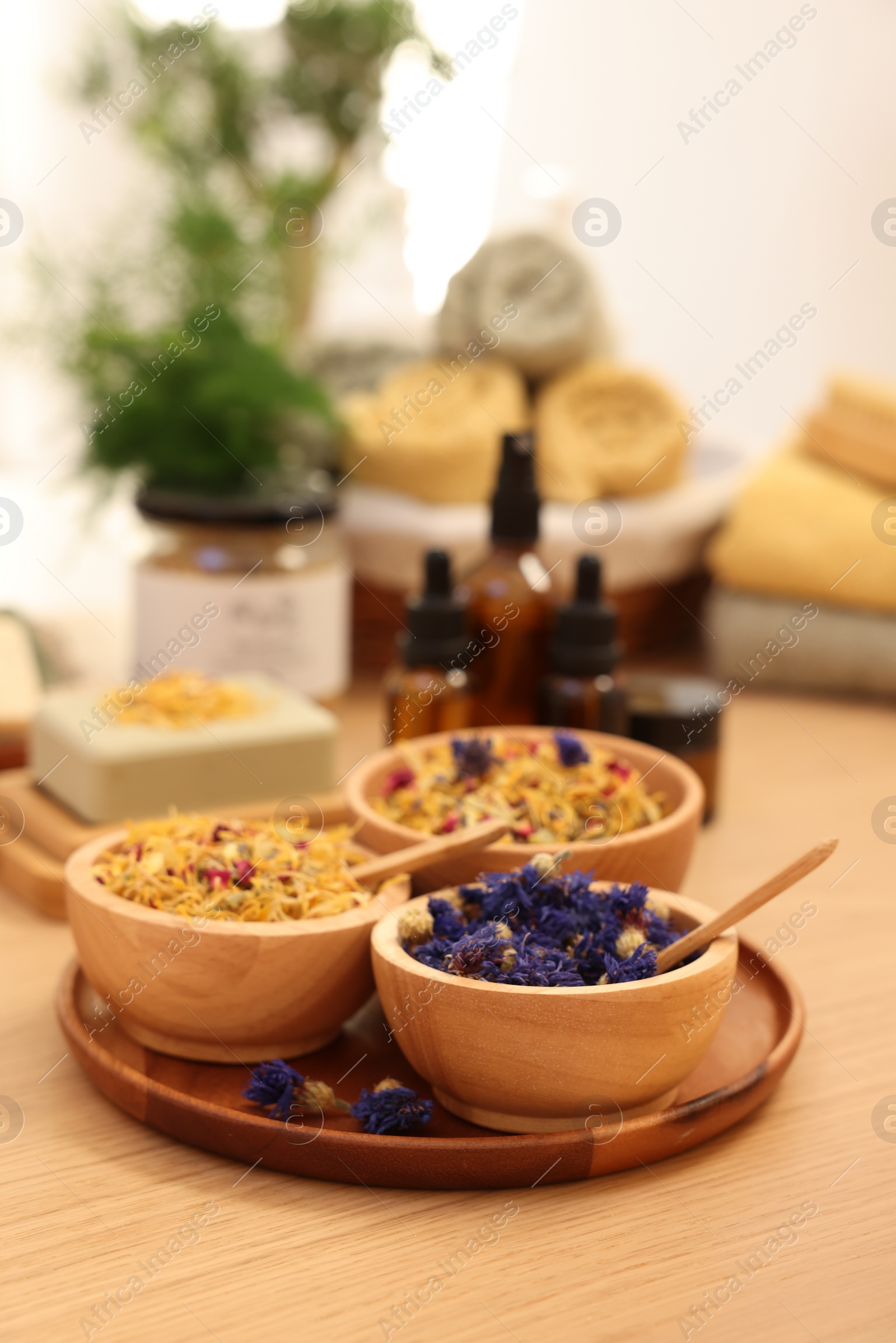 Photo of Dry flowers on wooden table indoors, space for text. Spa time