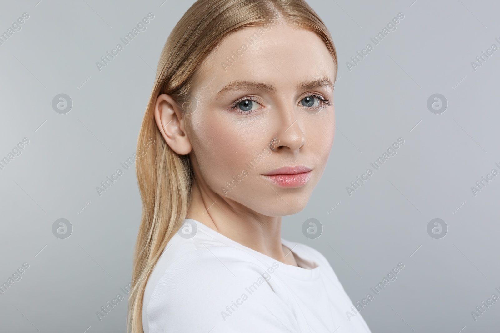 Photo of Portrait of beautiful young woman on grey background