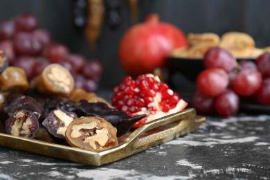 Photo of Delicious sweet churchkhelas and ingredients on textured table, closeup. Space for text