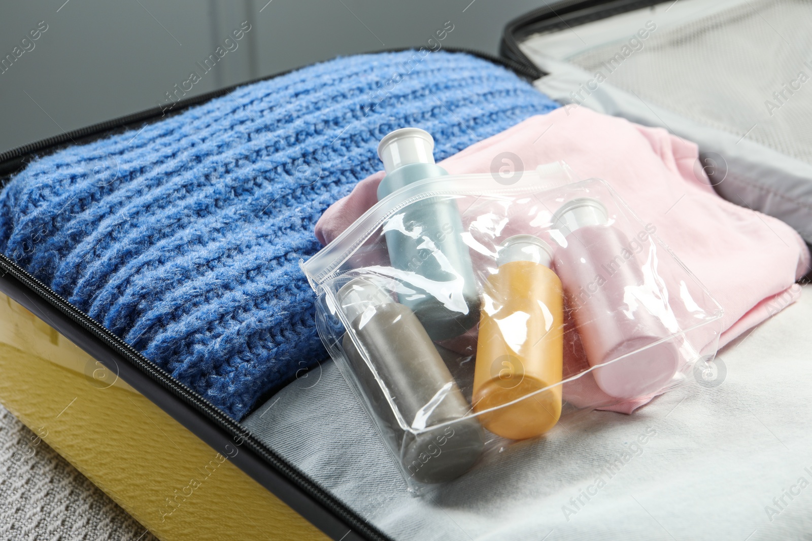 Photo of Plastic bag of cosmetic travel kit in suitcase