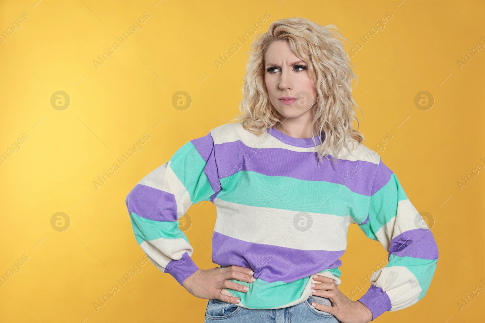 Photo of Portrait of thoughtful young woman on orange background. Space for text