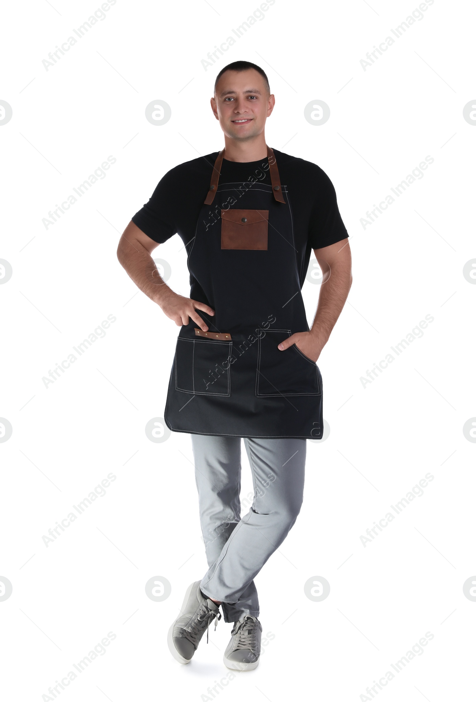 Photo of Full length portrait of happy young waiter in uniform on white background