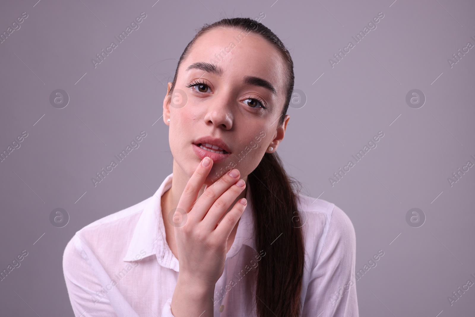 Photo of Portrait of beautiful young woman posing on light grey background