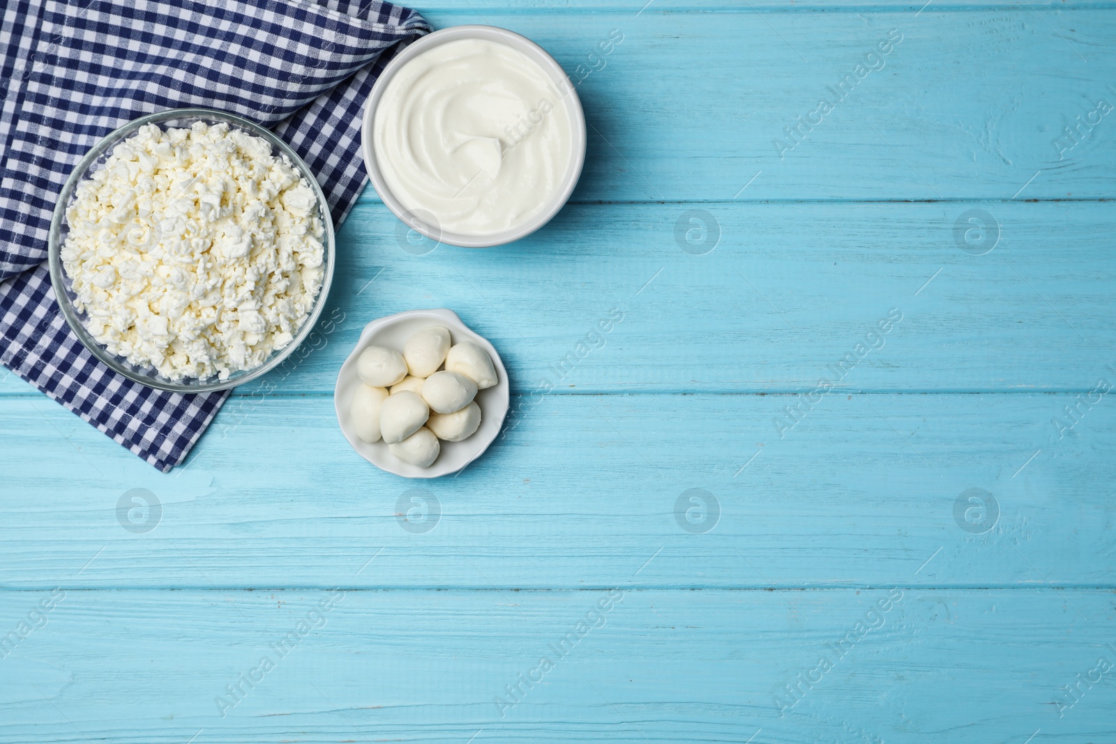 Photo of Fresh dairy products on wooden background, top view