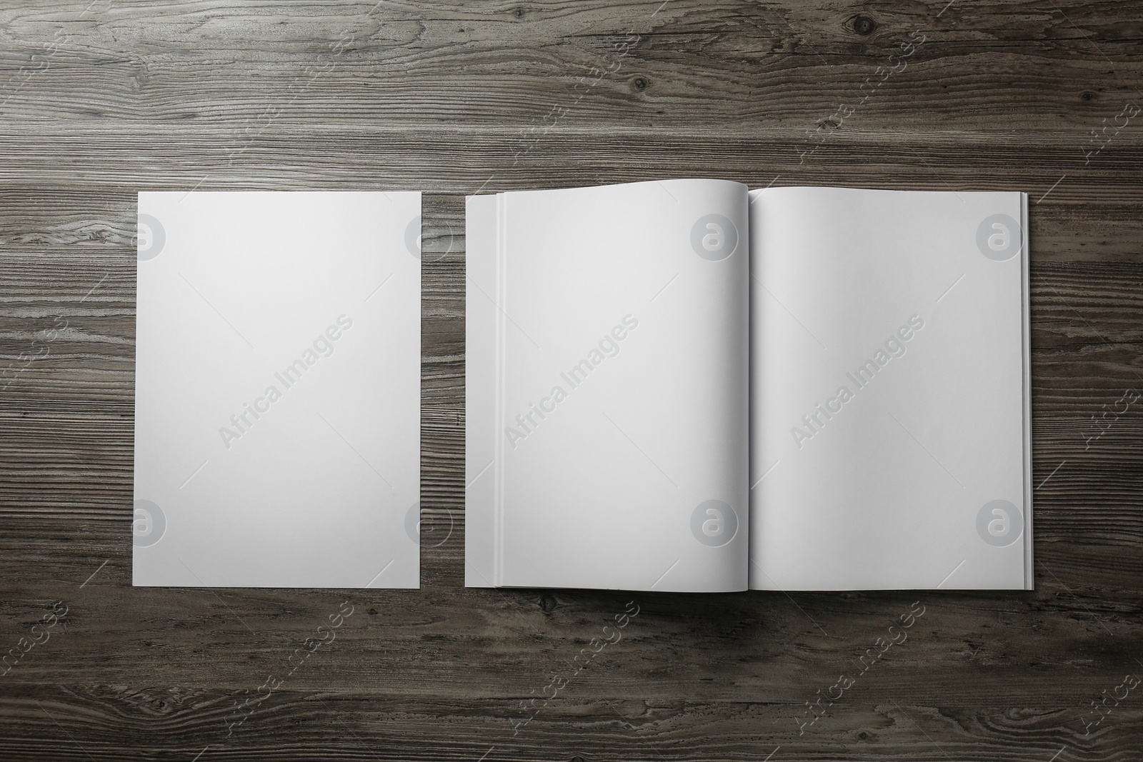 Photo of Sheet of paper and blank brochure on wooden table, flat lay. Mockup for design