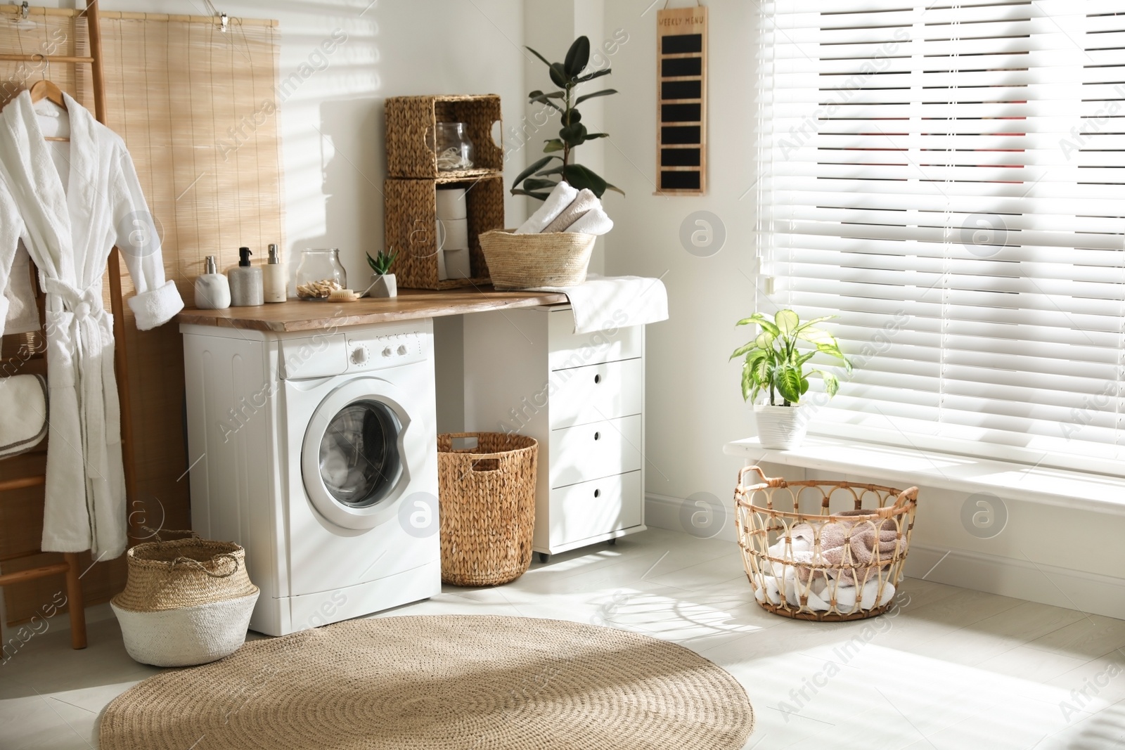 Photo of Stylish bathroom interior with modern washing machine