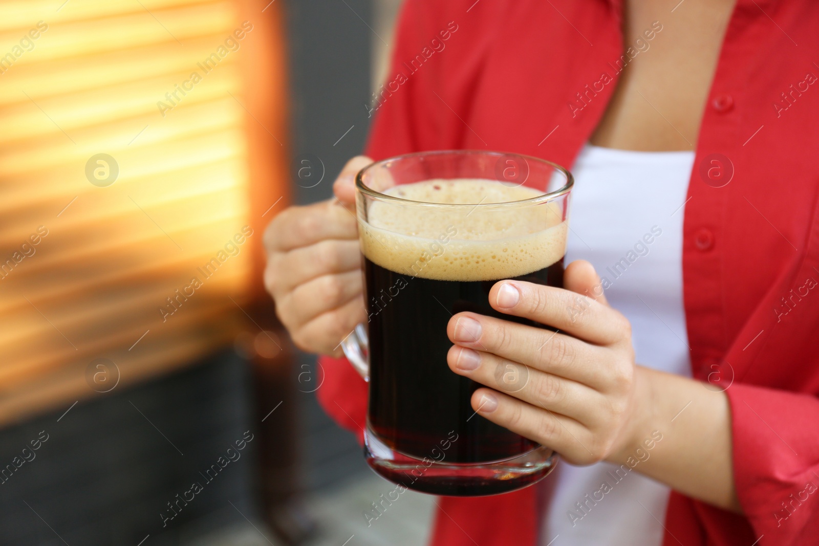 Photo of Young woman with cold kvass outdoors, closeup. Traditional Russian summer drink