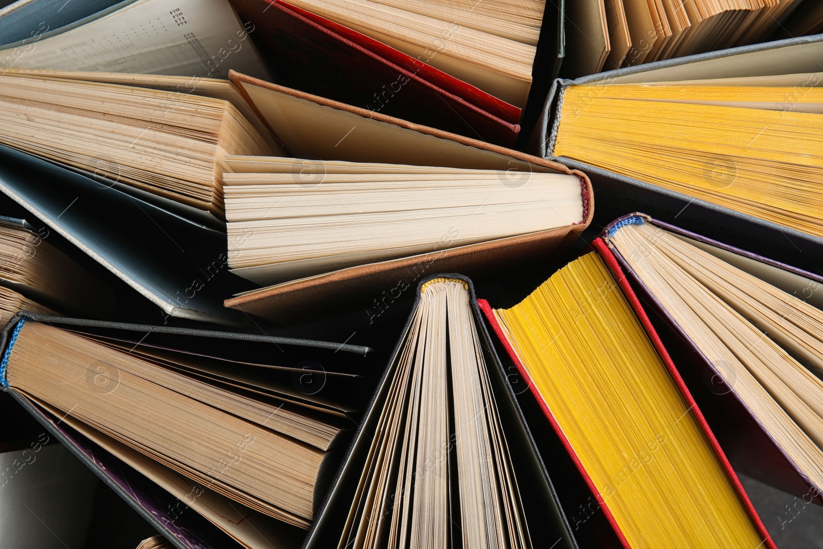 Photo of Stack of hardcover books as background, top view