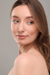 Photo of Beautiful woman with healthy skin on gray background